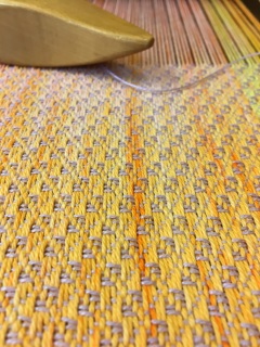 Shuttle on yellow threads